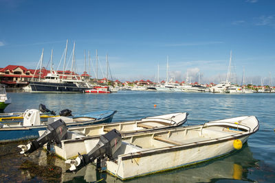 Old vintage fishing boats in sunny summer day at marina of eden island, mahe, seychelles