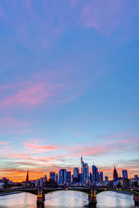 View of buildings in city at sunset