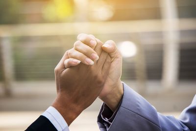 Close-up of business colleagues holding hands
