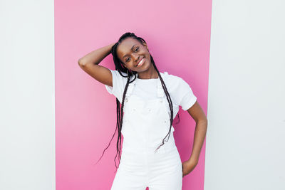 Smiling woman standing against colored background