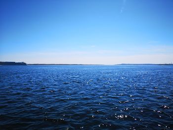 Scenic view of sea against blue sky