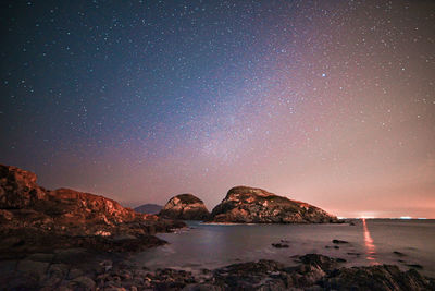 Scenic view of sea against sky at night