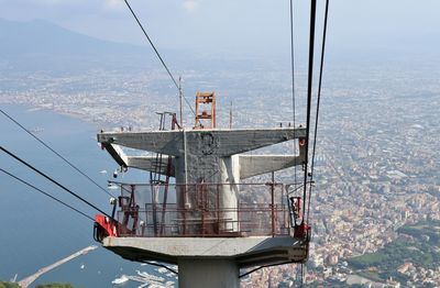 Overhead cable car over sea against sky