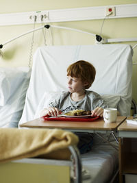 Boy eating meal in hospital