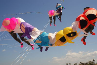 Low angle view of balloons flying against sky