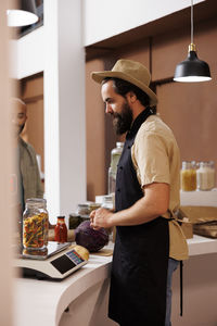 Side view of man working at table