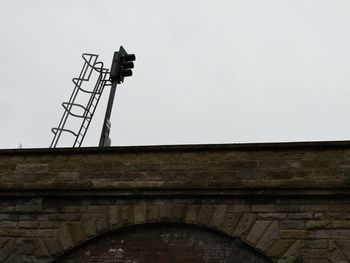 Low angle view of communications tower against clear sky