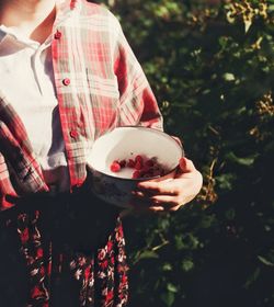 Close-up of man holding ice cream outdoors