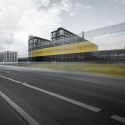 Road by building against sky