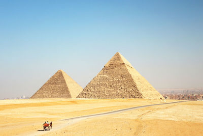 Scenic view of pyramids against sky