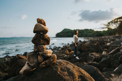 Stack of rocks on beach against sky