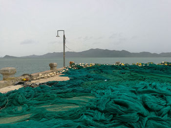 Scenic view of sea and mountains against sky