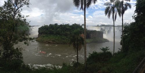 Scenic view of river against cloudy sky