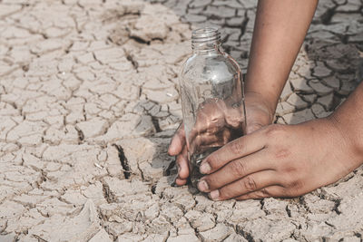 High angle view of man holding glass bottle