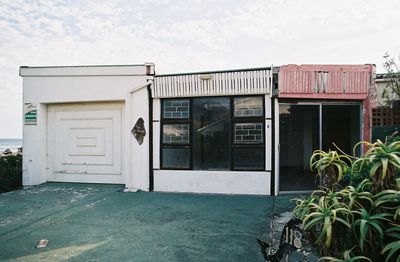 Exterior of house by swimming pool against sky