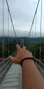 Midsection of woman in sea against sky