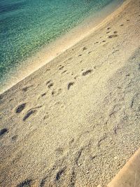 High angle view of tire tracks on beach