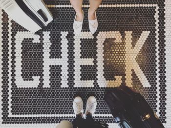 Low section of woman standing on tiled floor