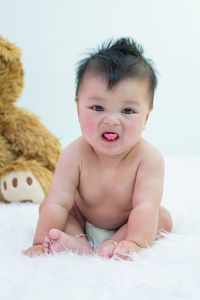 Portrait of cute baby on bed