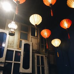 Low angle view of illuminated lanterns hanging at night