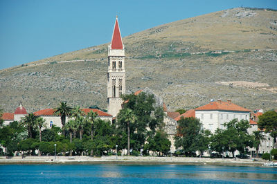 View of buildings at waterfront against sky