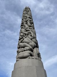 Low angle view of statue against cloudy sky