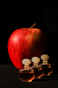 Close-up of apple on table against black background