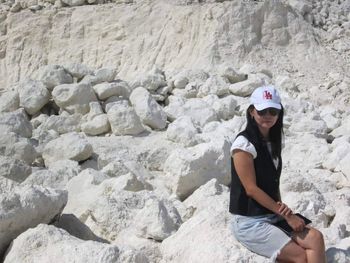 Full length of woman sitting on rock