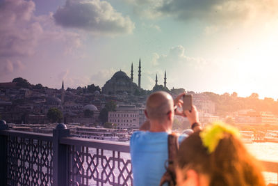 Panoramic view of city against sky during sunset