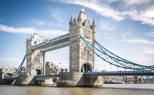 Tower bridge against cloudy sky