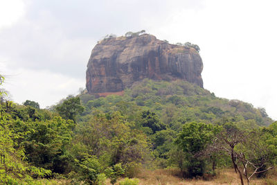 Rock formations on mountain against sky