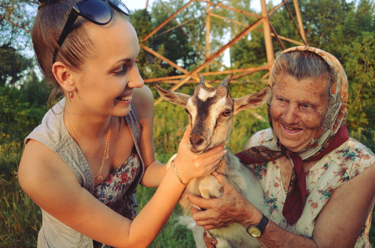 togetherness, two people, mammal, animal themes, domestic animals, friendship, outdoors, day, smiling, bonding, pets, real people, happiness, lifestyles, portrait, young women, tree, nature, young adult, adult, people