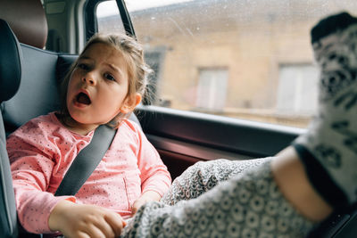 Cropped image of woman sitting in car