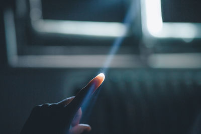 Sunlight streaming on hand of person