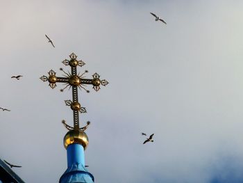 Low angle view of birds flying in sky