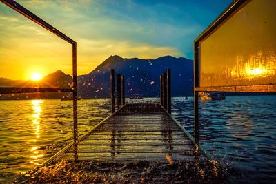 Scenic view of lake against sky during sunset