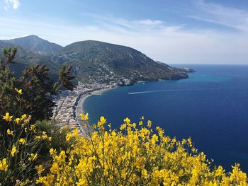 Scenic view of sea and mountains against sky