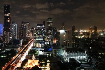 High angle view of illuminated buildings against sky at night