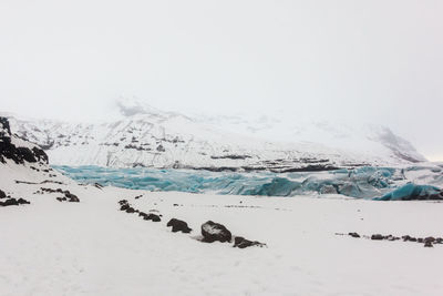 Scenic view of snow covered landscape during foggy weather