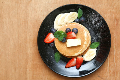 Directly above shot of fruits in plate on table