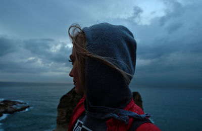 Portrait of woman looking at sea against sky