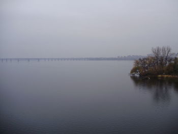 Scenic view of lake against sky during winter