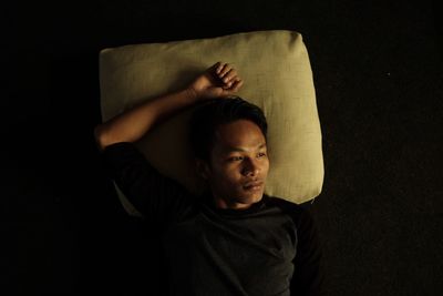 Portrait of boy against black background