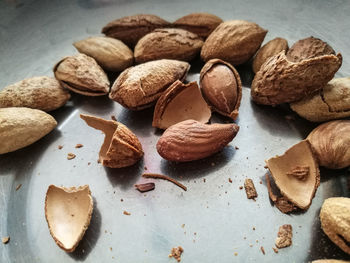 High angle view of cracked almonds in container