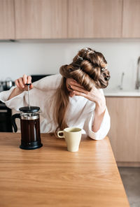 Woman holding coffee cup at home