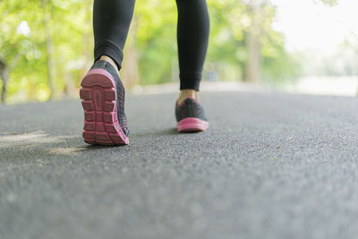 Low section of woman on road