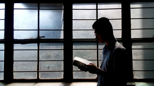 Man looking through window