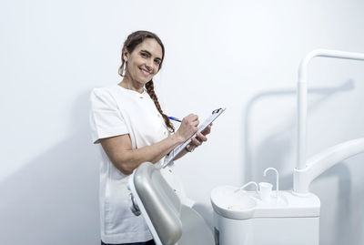 Portrait of young man washing hands in bathroom