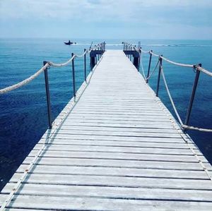 Pier over sea against sky