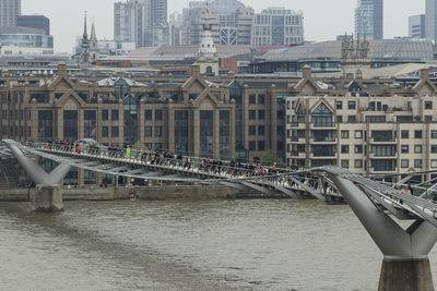 Bridge over river with buildings in background
